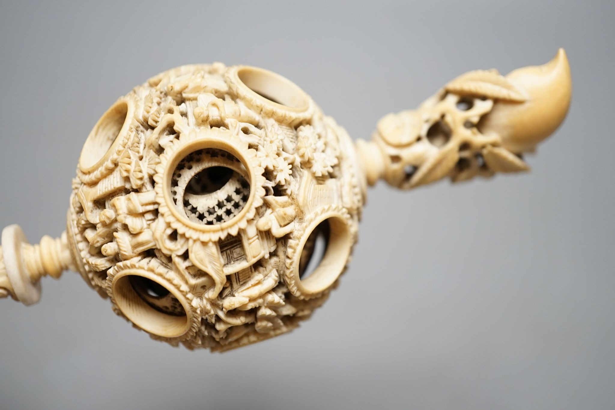 A 19th century Chinese export ivory puzzle ball., 31 cms long including chain.